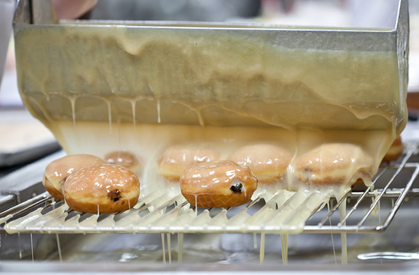 Glazing the paczki.