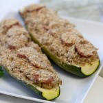Stuffed baked zucchini with rice, orzo and cherry tomatoes